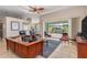 Spacious living room with pool view, recliner chairs, and large TV at 18138 Petoskey Cir, Port Charlotte, FL 33948