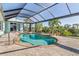 Inviting kidney-shaped pool with screened enclosure at 18138 Petoskey Cir, Port Charlotte, FL 33948