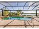 Relaxing pool area with screened enclosure and water views at 18138 Petoskey Cir, Port Charlotte, FL 33948