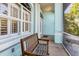 Covered porch with wooden bench, offering peaceful outdoor seating at 18138 Petoskey Cir, Port Charlotte, FL 33948