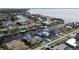 An aerial view of the home and community showing proximity to the surrounding waterfront at 225 Bangsberg Se Rd, Port Charlotte, FL 33952