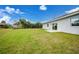 Spacious backyard with grassy area, providing ample space for outdoor activities at 2332 Brown St, Port Charlotte, FL 33948