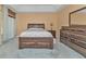 Bright bedroom with a double bed and dresser at 24088 Buckingham Way, Punta Gorda, FL 33980