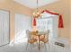 Cozy dining area with a round table and four chairs near a window at 24088 Buckingham Way, Punta Gorda, FL 33980