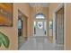 Bright and airy foyer with tile flooring and a half bathroom at 24088 Buckingham Way, Punta Gorda, FL 33980
