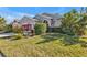Single-story house with lush landscaping and attractive curb appeal at 24088 Buckingham Way, Punta Gorda, FL 33980