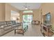 Spacious living area featuring a comfortable sofa and large windows at 24088 Buckingham Way, Punta Gorda, FL 33980