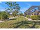Landscaped backyard with mature trees and lush greenery at 26081 Templar Ln, Punta Gorda, FL 33983