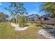 Landscaped backyard with mature trees and lush greenery at 26081 Templar Ln, Punta Gorda, FL 33983