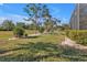 Landscaped backyard with mature trees and lush greenery at 26081 Templar Ln, Punta Gorda, FL 33983