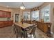 Sunlit dining room with wood table and chairs, near kitchen at 26081 Templar Ln, Punta Gorda, FL 33983