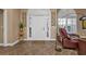 Bright entryway with tiled floors and a comfortable seating area at 26081 Templar Ln, Punta Gorda, FL 33983