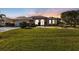 Well maintained single story home with a metal roof, and a neatly landscaped lawn at 26081 Templar Ln, Punta Gorda, FL 33983