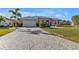 Cobblestone driveway and walkway leading to a beautiful single story home at 26081 Templar Ln, Punta Gorda, FL 33983