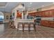 Kitchen with breakfast bar, granite counters, and wood cabinets at 26081 Templar Ln, Punta Gorda, FL 33983