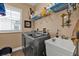 Bright laundry room with washer, dryer, and storage shelves at 26081 Templar Ln, Punta Gorda, FL 33983