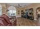 Spacious living room with leather armchairs, large TV, and tiled floor at 26081 Templar Ln, Punta Gorda, FL 33983