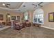 Bright living room featuring two leather armchairs and a large window at 26081 Templar Ln, Punta Gorda, FL 33983