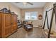 Home office with built-in wooden wardrobe and comfortable armchair at 26081 Templar Ln, Punta Gorda, FL 33983