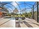 Screened pool and patio with lush landscape views at 26081 Templar Ln, Punta Gorda, FL 33983