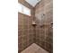 Walk-in shower with tiled walls and built-in shelf at 26081 Templar Ln, Punta Gorda, FL 33983