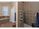 Walk-in shower with multiple shower heads, tiled walls, and a built-in shelf at 26081 Templar Ln, Punta Gorda, FL 33983