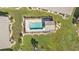 Aerial view of community pool and surrounding landscape at 26155 Explorer Rd # 1C, Punta Gorda, FL 33983