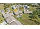 Aerial view showing a community of villas, pool, and surrounding landscape at 26155 Explorer Rd # 1C, Punta Gorda, FL 33983