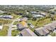 Aerial view of a villa community with a pool and lush landscaping at 26155 Explorer Rd # 1C, Punta Gorda, FL 33983