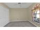 Bright bedroom featuring double door closet and window at 26155 Explorer Rd # 1C, Punta Gorda, FL 33983