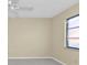 Simple bedroom with ceiling fan and window at 26155 Explorer Rd # 1C, Punta Gorda, FL 33983