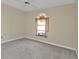 Spacious bedroom with carpeted floor and arched window at 26155 Explorer Rd # 1C, Punta Gorda, FL 33983