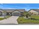 Front view of charming villa with two-car garage and landscaped yard at 26155 Explorer Rd # 1C, Punta Gorda, FL 33983