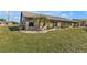 Back exterior view of house with landscaping at 26155 Explorer Rd # 1C, Punta Gorda, FL 33983
