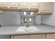 Bright kitchen features granite countertops and updated sink at 26155 Explorer Rd # 1C, Punta Gorda, FL 33983