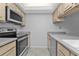 View of kitchen with updated appliances and countertops at 26155 Explorer Rd # 1C, Punta Gorda, FL 33983