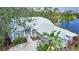 White house near water with tile roof and lush landscaping at 3116 Silkwood Ln, Port Charlotte, FL 33953