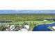 Houses and golf course with a pond and lush green trees at 3116 Silkwood Ln, Port Charlotte, FL 33953
