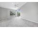 Bright bedroom featuring a ceiling fan and access to patio at 3116 Silkwood Ln, Port Charlotte, FL 33953