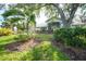 Backyard view of home with mature trees at 3116 Silkwood Ln, Port Charlotte, FL 33953