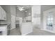 Kitchen with white cabinets, built-in desk, and view to living area at 3116 Silkwood Ln, Port Charlotte, FL 33953