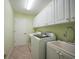 Laundry room with washer, dryer, and cabinets at 3116 Silkwood Ln, Port Charlotte, FL 33953