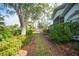 Landscaped yard leading to water view at 3116 Silkwood Ln, Port Charlotte, FL 33953