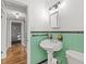 Bathroom with mint green tile and pedestal sink at 330 45Th S St, St Petersburg, FL 33711