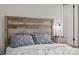 Closeup of a bedroom with a wooden headboard and gray pillows at 330 45Th S St, St Petersburg, FL 33711