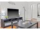 Living room with hardwood floors, gray sectional sofa, and a large TV at 330 45Th S St, St Petersburg, FL 33711