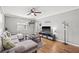 Spacious living room with hardwood floors, gray sectional sofa, and a large TV at 330 45Th S St, St Petersburg, FL 33711