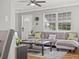 Living room with hardwood floors, gray sectional sofa, and a wood coffee table at 330 45Th S St, St Petersburg, FL 33711
