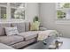 Living room with hardwood floors, gray sectional sofa, and a large window at 330 45Th S St, St Petersburg, FL 33711