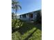 House exterior with a well-maintained lawn and canal view at 4156 Bardot Rd, Port Charlotte, FL 33953